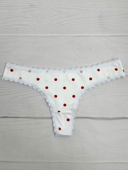 Tanga lisa marfil puntos naranja