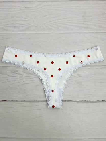 Tanga lisa marfil puntos naranja